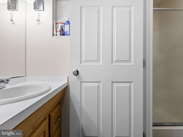 bathroom with a shower stall and vanity