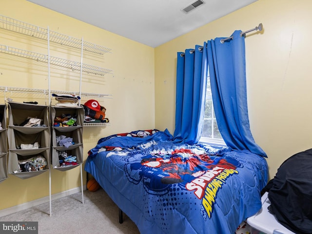 carpeted bedroom with visible vents and baseboards