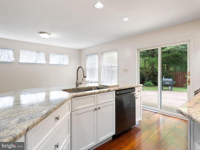 kitchen with dishwasher, a wealth of natural light, dark wood-type flooring, and a sink