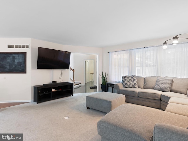living room featuring baseboards, visible vents, and carpet floors
