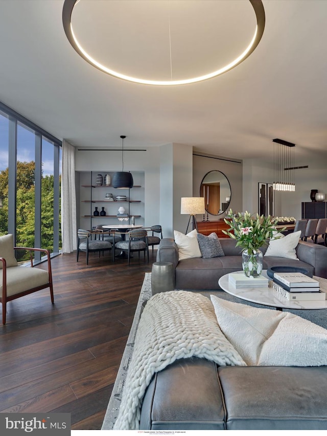 living area featuring floor to ceiling windows and dark wood-style floors