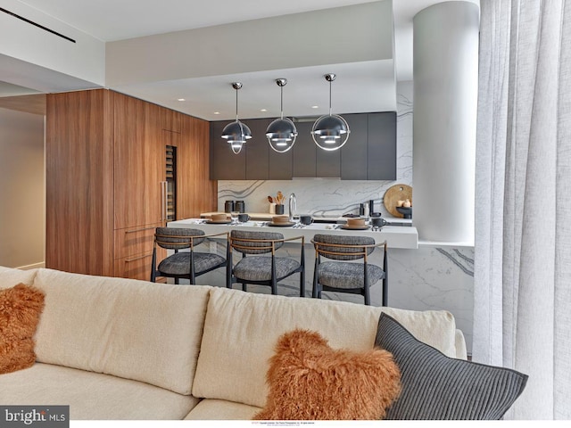 kitchen featuring a sink, modern cabinets, decorative light fixtures, tasteful backsplash, and recessed lighting