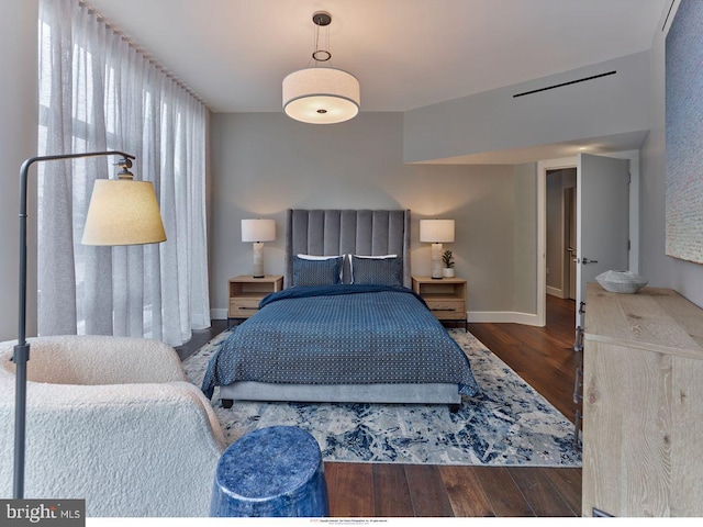 bedroom with wood finished floors and baseboards