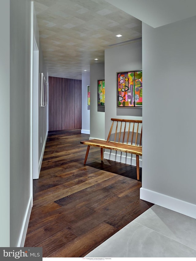 hallway with wood finished floors, baseboards, and recessed lighting