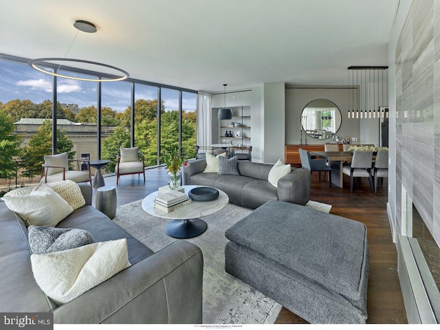 living room with floor to ceiling windows and wood finished floors
