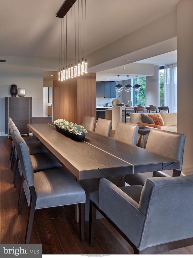 dining area featuring baseboards, dark wood-style floors, and visible vents