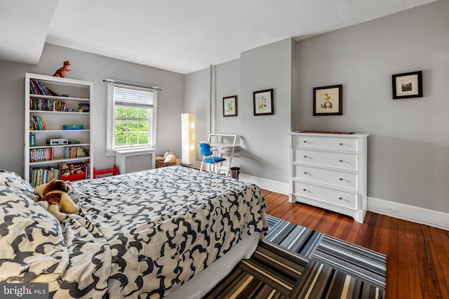 bedroom with wood-type flooring and baseboards