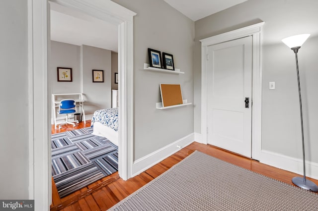 interior space with baseboards and wood finished floors