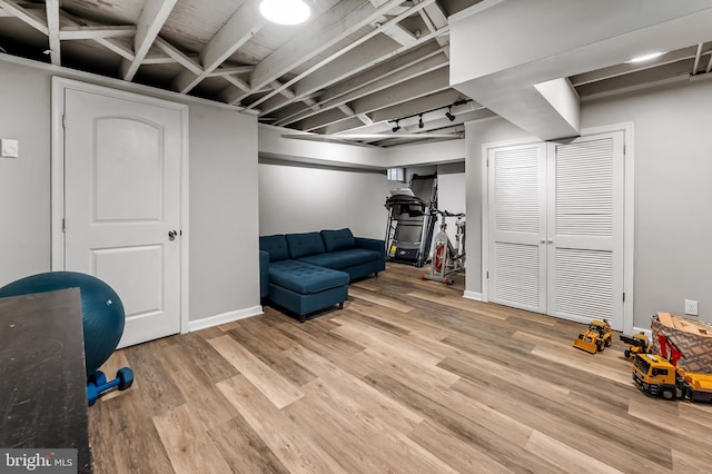 interior space with baseboards and wood finished floors