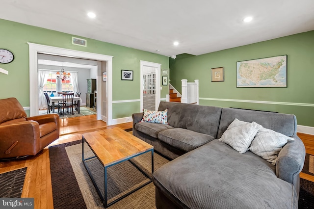 living area with baseboards, light wood-type flooring, visible vents, and recessed lighting