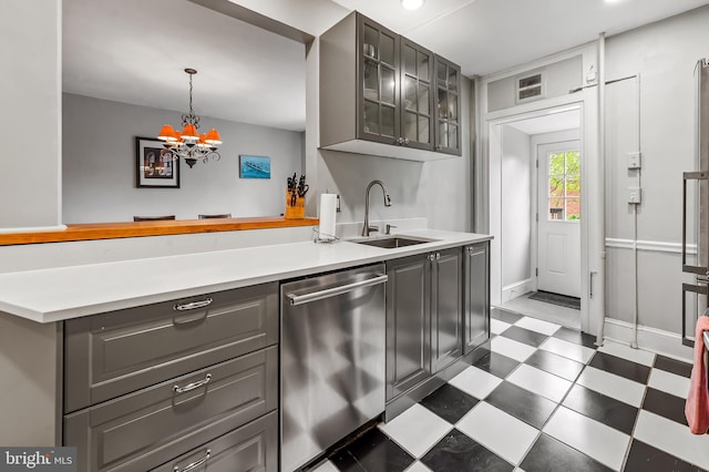 kitchen with a sink, dark floors, gray cabinets, glass insert cabinets, and stainless steel dishwasher