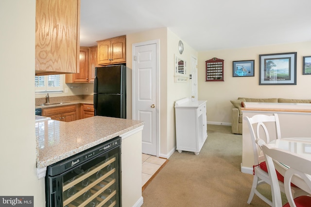 6018 Good Lion Ct, Alexandria, VA 22315 - kitchen featuring freestanding refrigerator, beverage cooler, a sink, light carpet, and baseboards