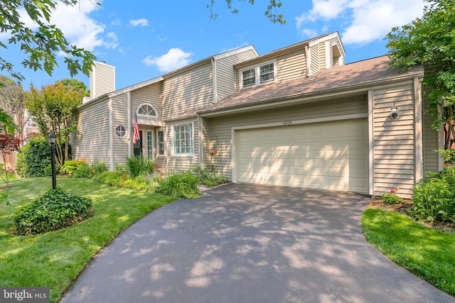 6018 Good Lion Ct, Alexandria, VA 22315 - view of front of home featuring a garage, asphalt driveway, a front lawn, and a chimney