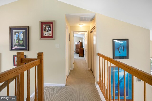 6018 Good Lion Ct, Alexandria, VA 22315 - hall with an upstairs landing, light carpet, baseboards, and lofted ceiling