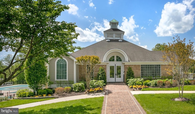 6018 Good Lion Ct, Alexandria, VA 22315 - view of front of house with french doors, a front yard, brick siding, and a shingled roof