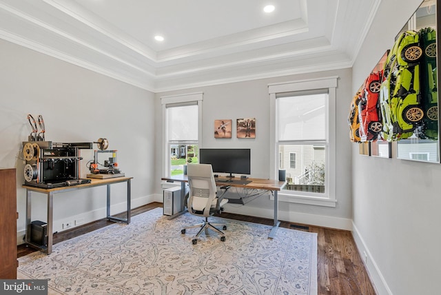 office space with wood finished floors, a raised ceiling, baseboards, ornamental molding, and recessed lighting