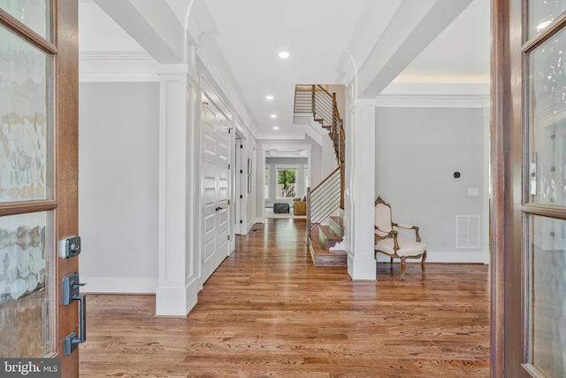 entrance foyer featuring light wood-type flooring, stairway, recessed lighting, baseboards, and crown molding