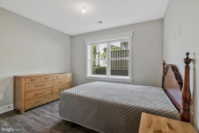 bedroom with dark wood-style floors and baseboards