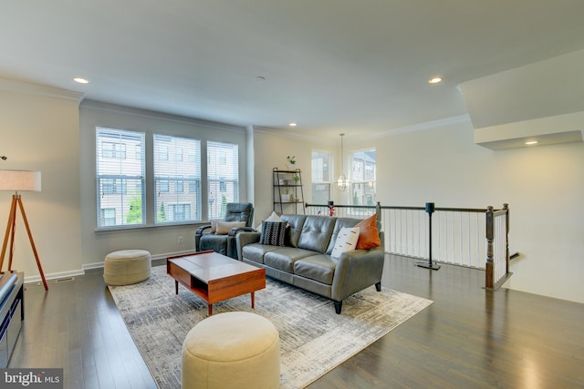 living area featuring ornamental molding, healthy amount of natural light, wood finished floors, recessed lighting, and baseboards