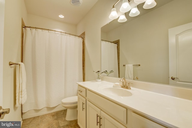 bathroom featuring toilet, vanity, and tile patterned flooring