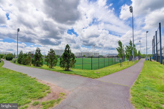 surrounding community with a tennis court