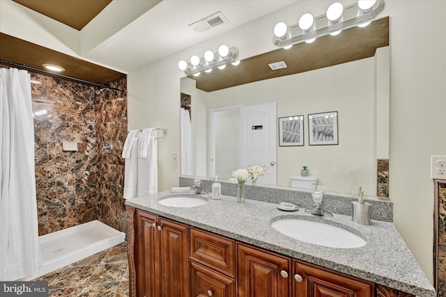 bathroom with a shower with shower curtain and double vanity
