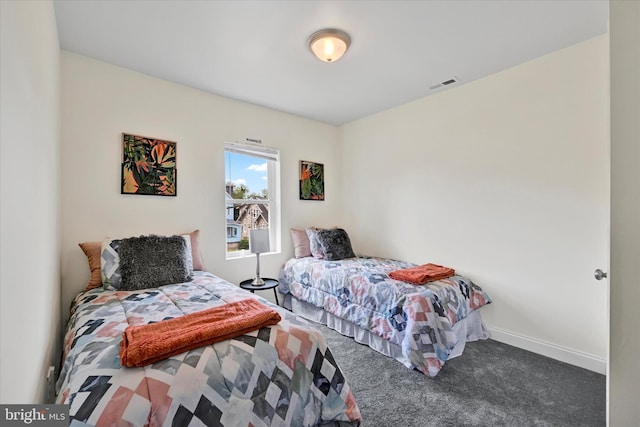 carpeted bedroom featuring baseboards