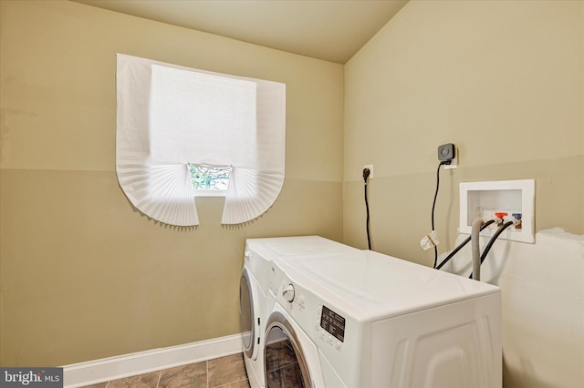 washroom with washer and clothes dryer and baseboards