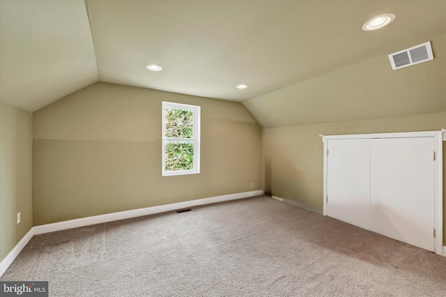 additional living space featuring lofted ceiling, carpet flooring, baseboards, and recessed lighting