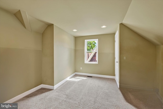 additional living space with lofted ceiling, baseboards, carpet, and recessed lighting