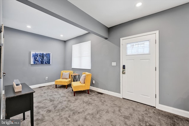 foyer featuring carpet floors, baseboards, and recessed lighting