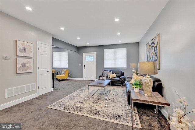 carpeted living area with recessed lighting and baseboards