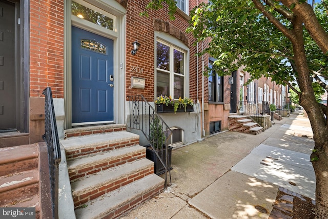 property entrance with brick siding
