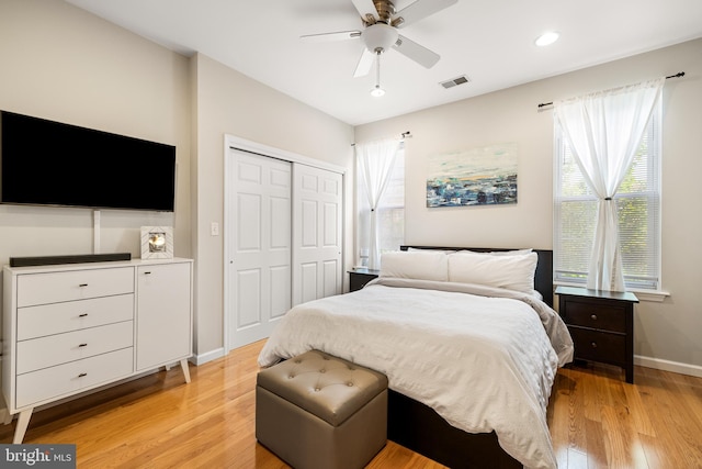 bedroom with light wood-style flooring, a closet, visible vents, baseboards, and recessed lighting