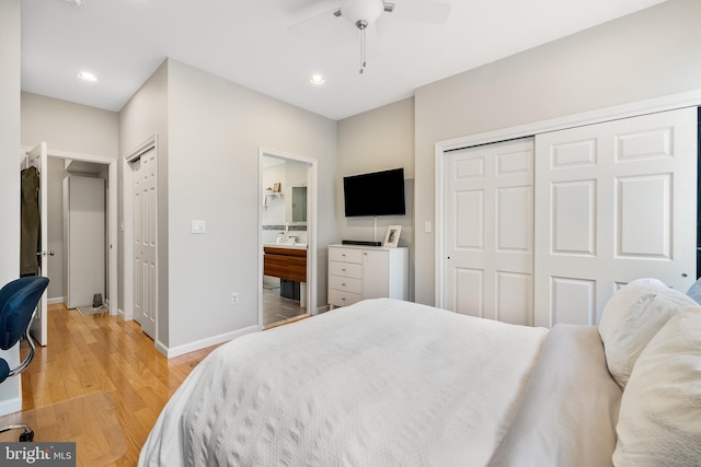 bedroom featuring a closet, light wood-style flooring, recessed lighting, baseboards, and ensuite bath
