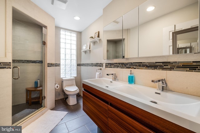 bathroom with a stall shower, tile walls, toilet, visible vents, and tile patterned floors