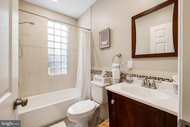 full bathroom with vanity, toilet, plenty of natural light, and shower / bath combo
