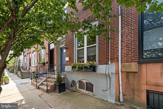 view of side of property with brick siding