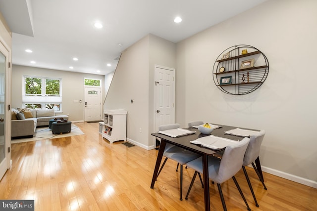 dining space with light wood-type flooring, baseboards, and recessed lighting