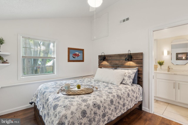 1215 Pine Ave, Shady Side, MD 20764 - bedroom with ensuite bath, vaulted ceiling, wood finished floors, and baseboards