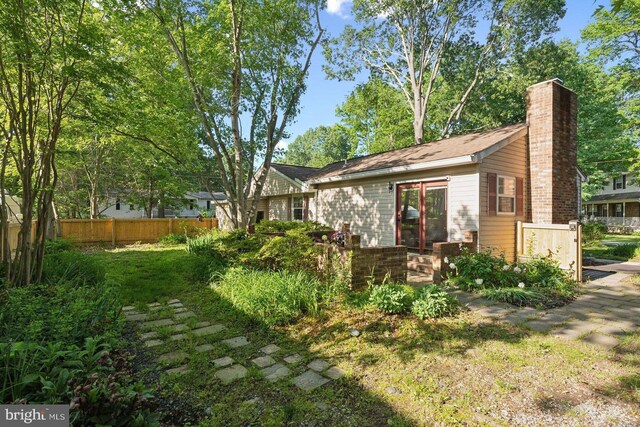 1215 Pine Ave, Shady Side, MD 20764 - rear view of property with fence and a chimney