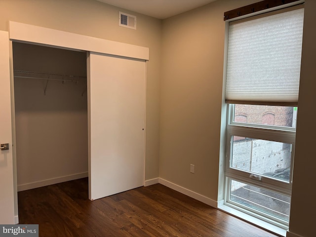1501 N 31st St Unit 305, Philadelphia, PA 19121 - unfurnished bedroom featuring a closet, dark wood-style flooring, and baseboards
