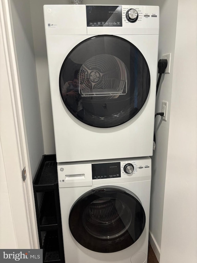 1501 N 31st St Unit 305, Philadelphia, PA 19121 - washroom with stacked washing machine and dryer and baseboards