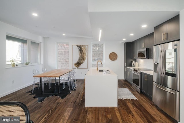 1501 N 31st St Unit 305, Philadelphia, PA 19121 - kitchen featuring appliances with stainless steel finishes, dark wood-style floors, a sink, baseboards, and light countertops