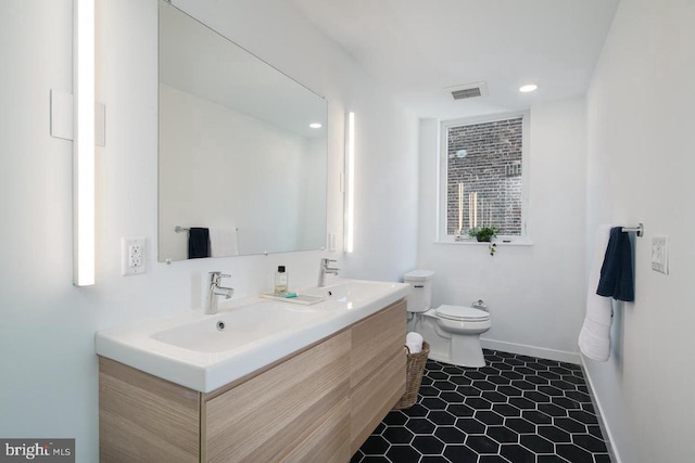 1501 N 31st St Unit 305, Philadelphia, PA 19121 - full bathroom with double vanity, toilet, baseboards, tile patterned flooring, and recessed lighting