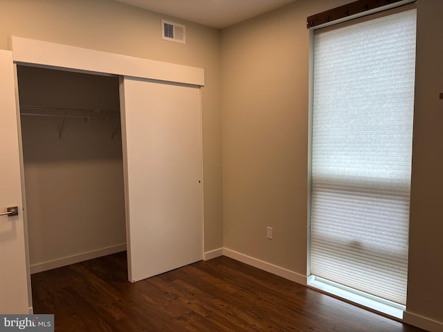 1501 N 31st St Unit 305, Philadelphia, PA 19121 - unfurnished bedroom with a closet, dark wood finished floors, and baseboards