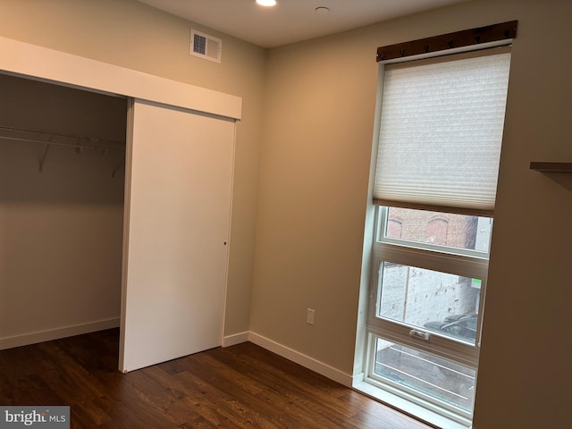 1501 N 31st St Unit 305, Philadelphia, PA 19121 - unfurnished bedroom featuring a closet, multiple windows, dark wood-style flooring, baseboards, and recessed lighting