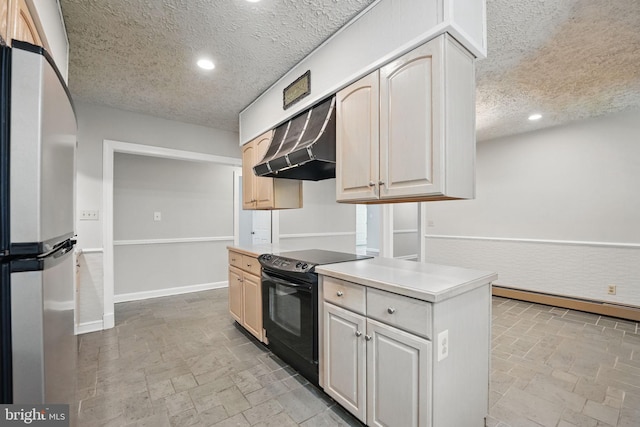 kitchen featuring freestanding refrigerator, black range with electric stovetop, stone tile floors, a textured ceiling, and under cabinet range hood