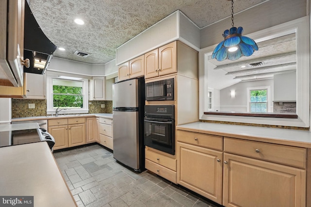 kitchen featuring a sink, light brown cabinets, black appliances, and tasteful backsplash