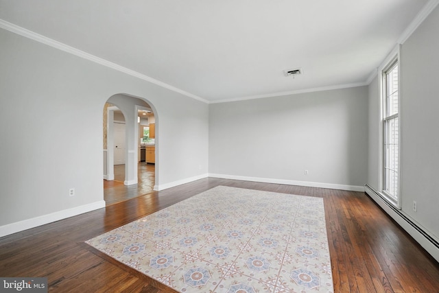 unfurnished room with a healthy amount of sunlight, baseboard heating, and visible vents